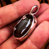 Oval shaped Sterling Silver Artwork Pendant with a black Agate cabochon