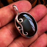 Oval shaped Sterling Silver Artwork Pendant with a black Agate cabochon