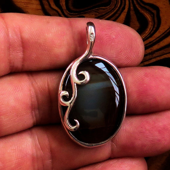 Oval shaped Sterling Silver Artwork Pendant with a black Agate cabochon