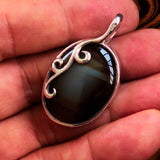 Oval shaped Sterling Silver Artwork Pendant with a black Agate cabochon